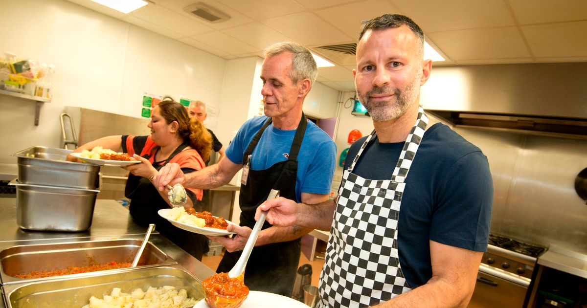 Ryan Giggs serves meals to homeless people at the Booth Centre