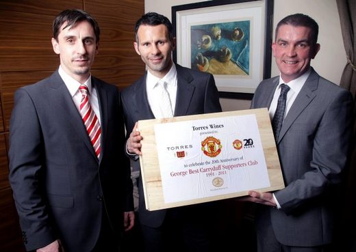 Gift sets are presented to Ryan Giggs and Gary Neville by Gareth Bradley, managi